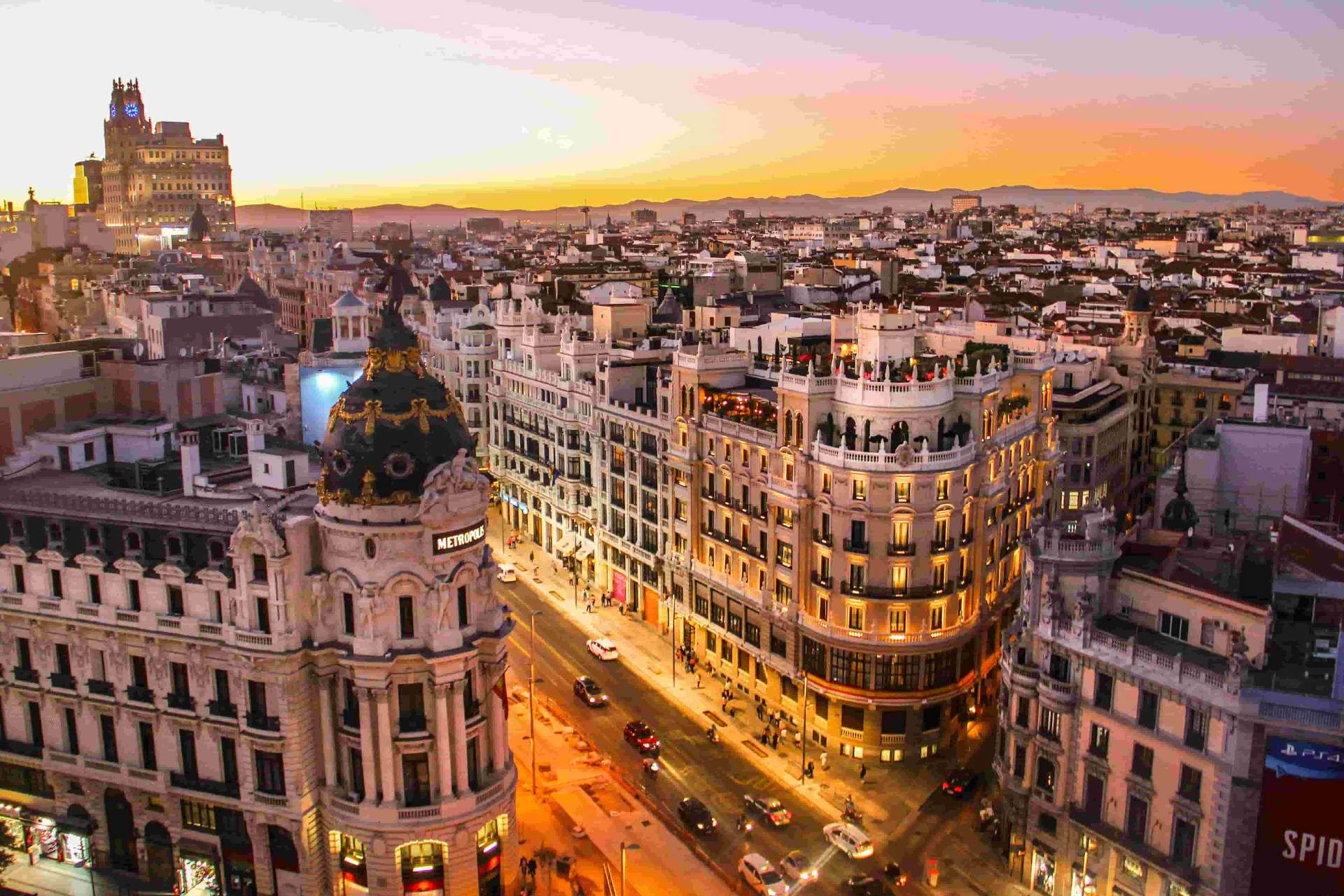Madrid Gran Via at sunset with Metropolis building - buying a car in Spain