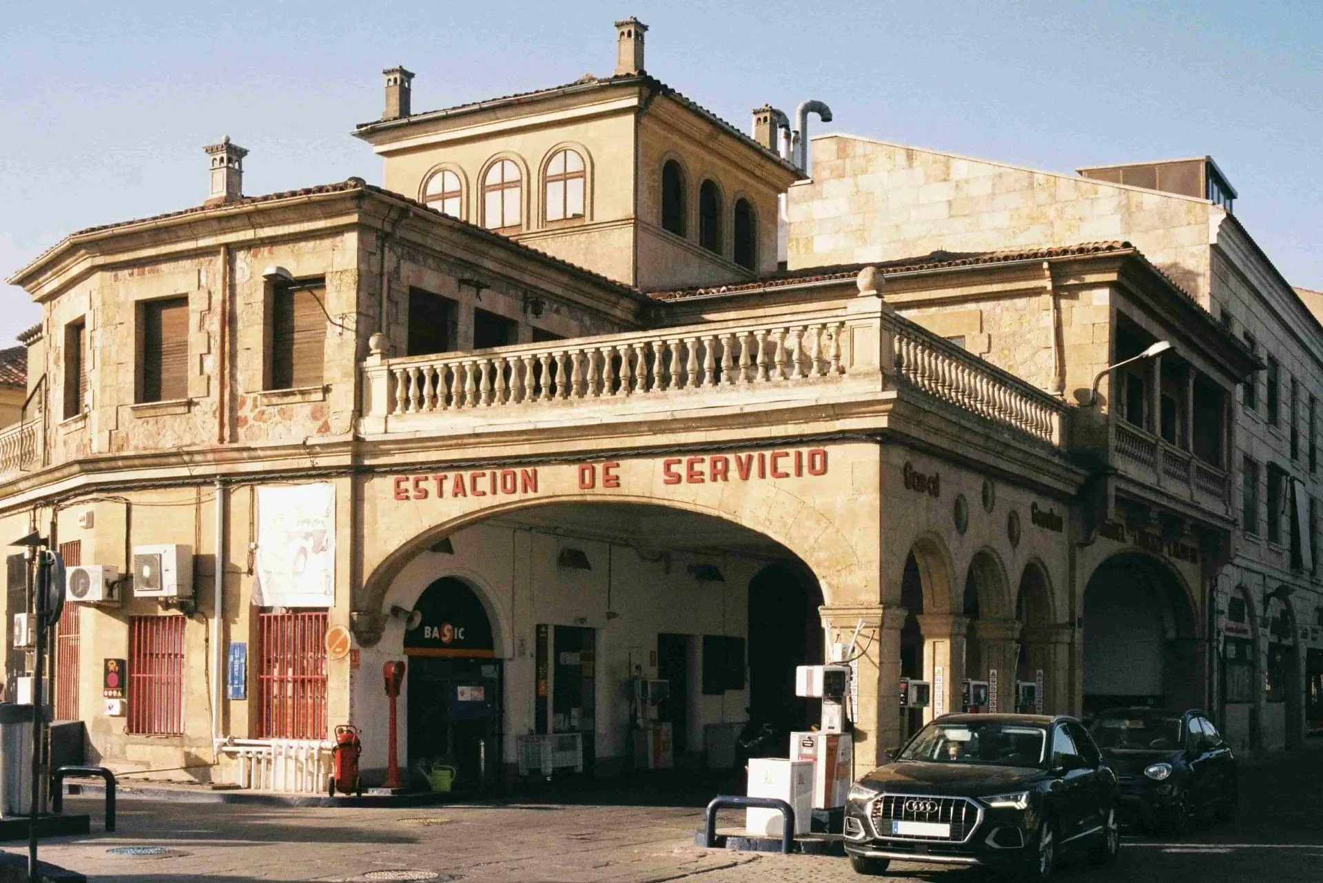Traditional service station in Spain with cars parked outside, illustrating public liability risks for small businesses
